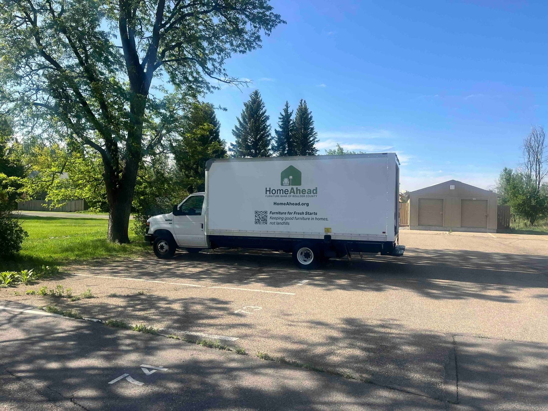 The white HomeAhead box truck with the logo and 'Furniture for Fresh Starts' on its side